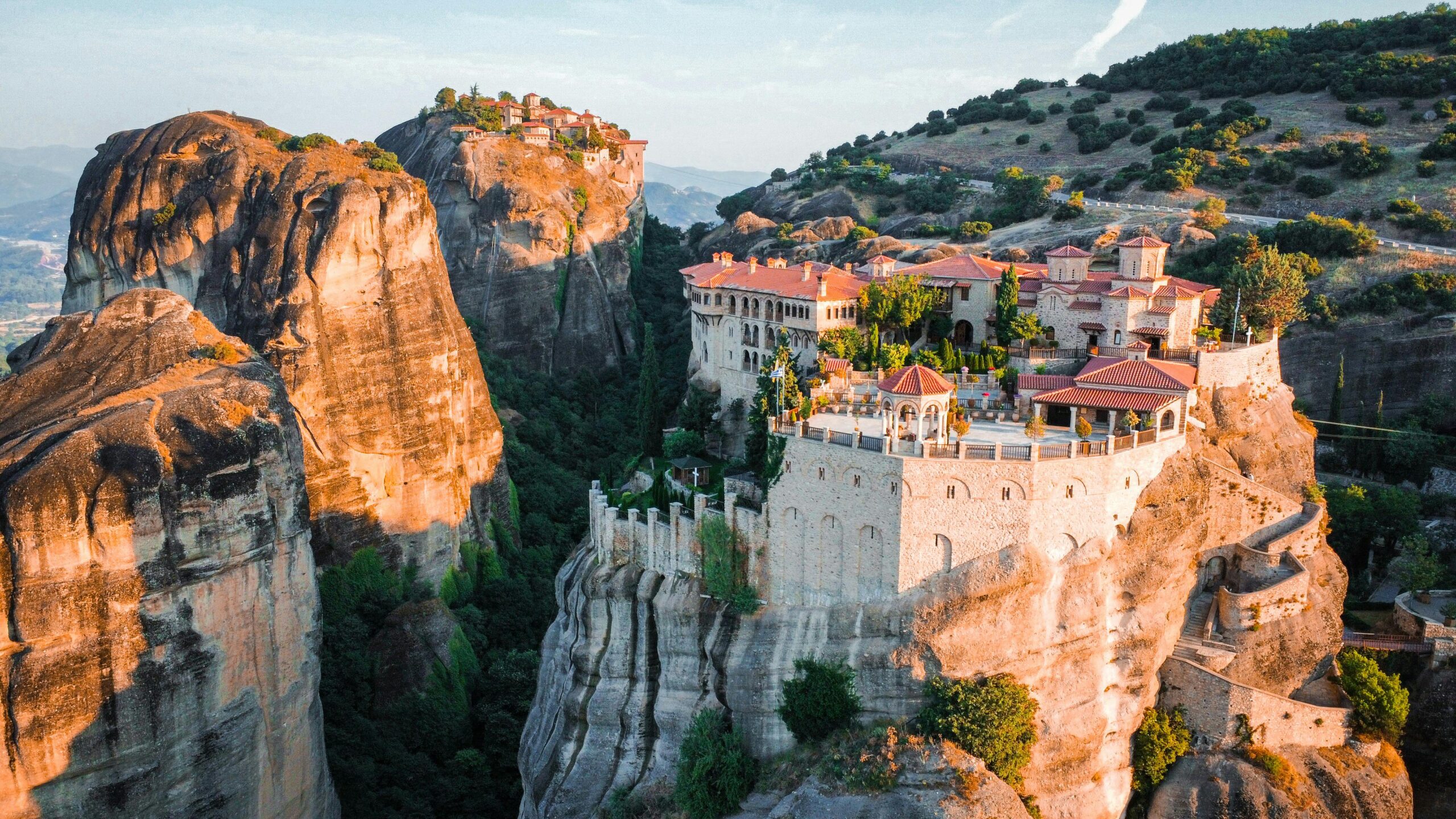Breathtaking aerial view of Meteora monasteries perched on rock formations in Kalampaka, Greece.